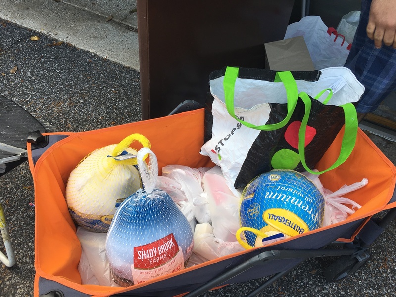 A cart of turkeys and food items waiting to be sorted for distribution