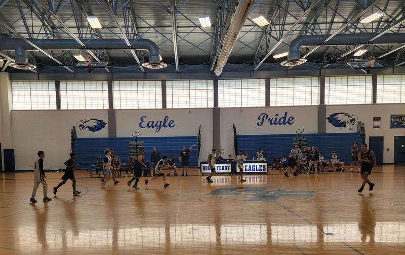 an image of the entire gym with the players playing and the score card in the background