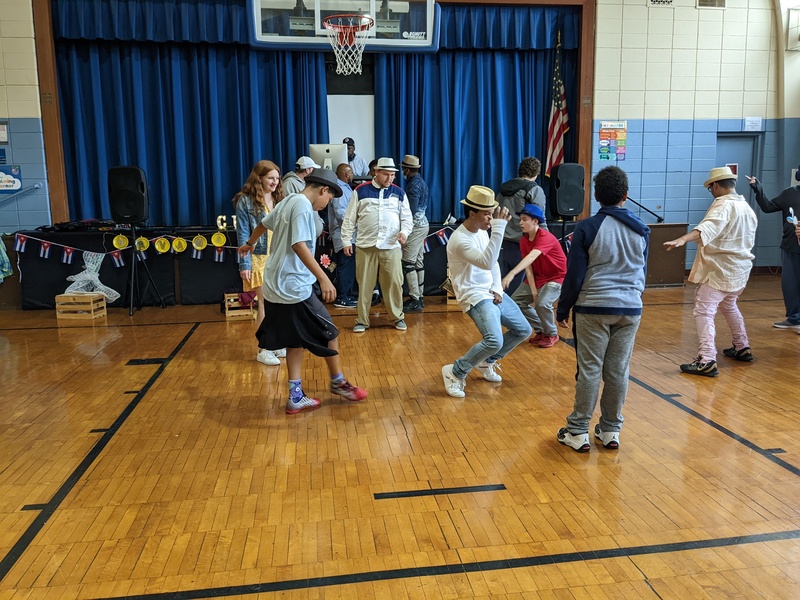 students dancing in the gym while wearing cuban hats